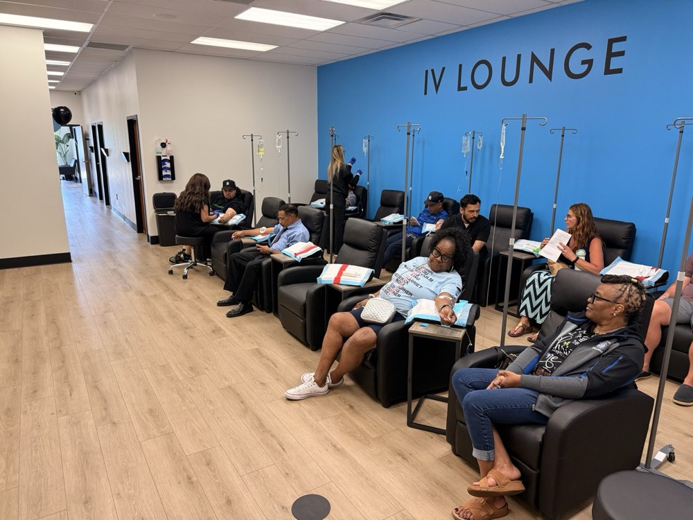 The IV Lounge full of guests receiving free vitamin IVs